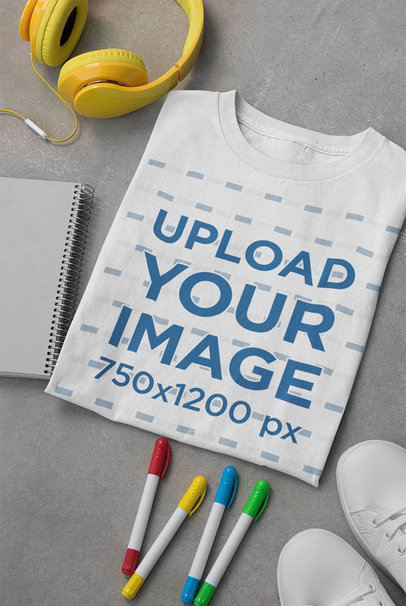 Mockup of a Folded T-Shirt Placed by a Pair of Sneakers and Headphones 33681