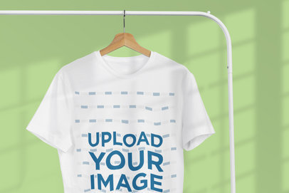 Mockup of a T-Shirt Hanging Near a Window and Featuring a Customizable Background 3727-el1
