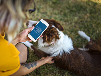 iPhone Mockup in Portrait Position of a Woman Petting Her Dog in a Park