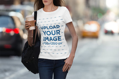 T-Shirt Mockup of a Woman Walking Down a Busy Street