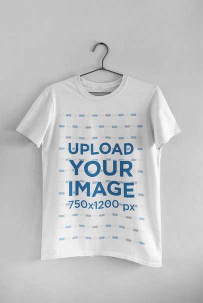 Mockup of a Basic Round Neck Tee Hanging on a Wall 