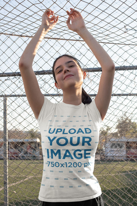 T-Shirt Mockup Featuring a Teen Posing by a Soccer Net