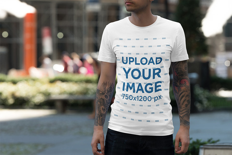 Tee Mockup Featuring a Man with Tattooed Arms on the Street 