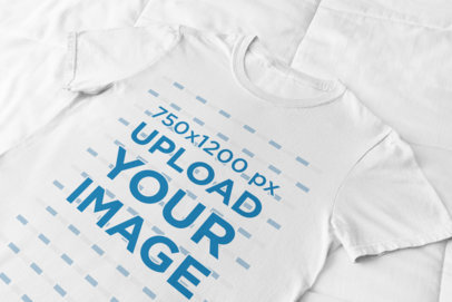 Front-View Mockup of a Flat Lay Tee Against a Soft Fabric 33942