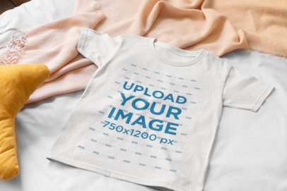 Mockup of a Flat Lay Tee Placed over a Bed 33946