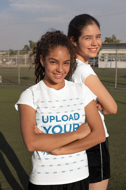 T-Shirt Mockup of Two Teenagers Posing at a Soccer Field 