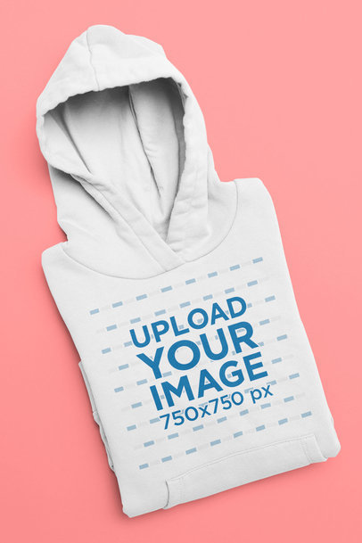 Mockup of a Folded Pullover Hoodie Against a Flat Surface