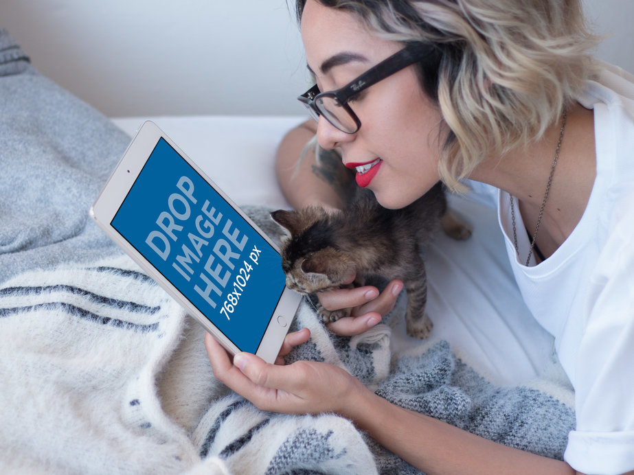 iPad Mockup in Portrait Position Featuring a Woman with a Kitten