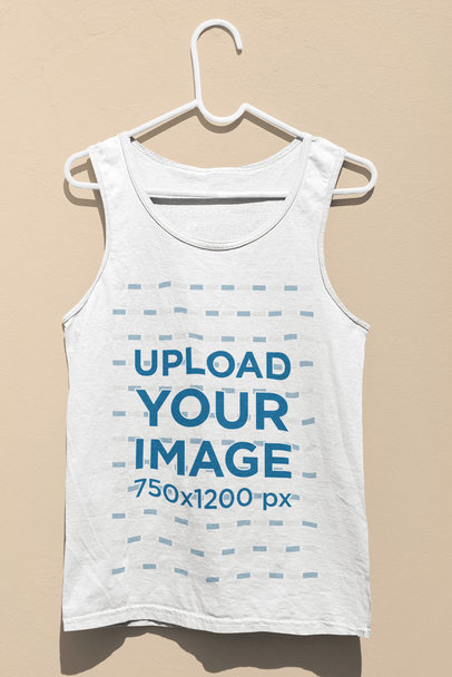 Mockup of a Tank Top Hanging Against a Wall