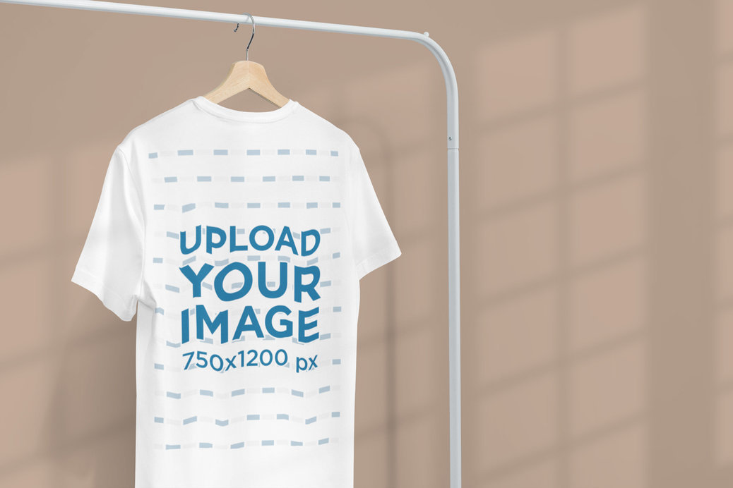 Minimal Apparel Mockup Featuring a Customizable T-Shirt Hanging From a Clothing Rack 