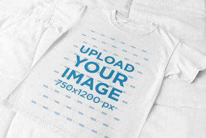 Flat Lay T-Shirt Mockup Placed over a Cotton-Fabric Surface 33944