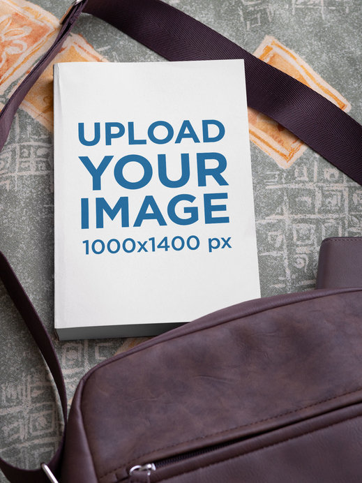 Mockup Featuring a Paperback Book Placed by a Bag 
