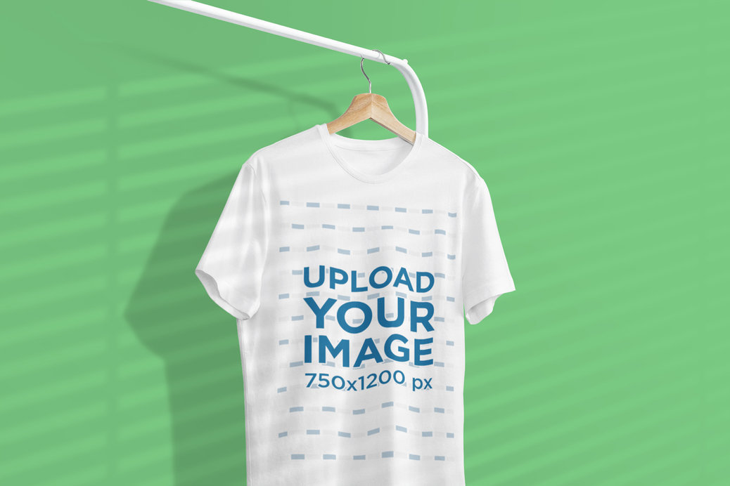 Mockup of a One Tee Hanging From a Clothing Rack Featuring a Background Shadow 