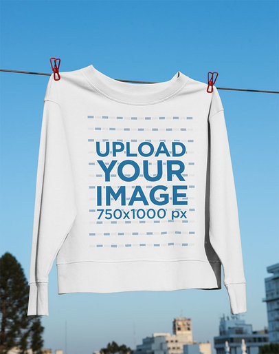 Mockup of a Crewneck Sweatshirt Hanging on a Clothesline 
