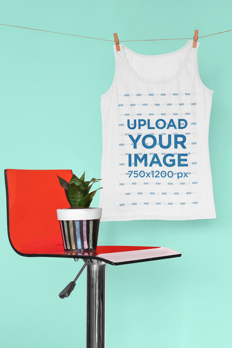 Mockup of a Tank Top Hanging By a Red Chair