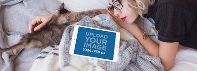 iPad Mockup in Landscape Position of a Woman Lying with a Kitten in Her Bed 12792wide