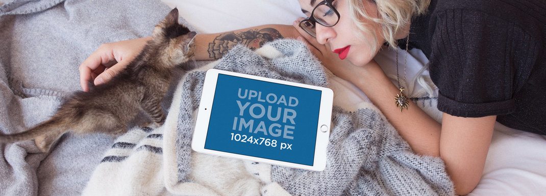 iPad Mockup in Landscape Position of a Woman Lying with a Kitten in Her Bed
