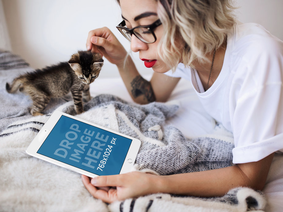 Hipster Woman Lying in her Bed with a Kitten and White iPad Mini Mockup
