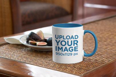 Mockup of an 11 oz Coffee Mug Next to a Fruit Plate