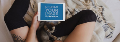 iPad Mockup in Landscape Position Featuring a Woman Sitting on a Bed 12812wide