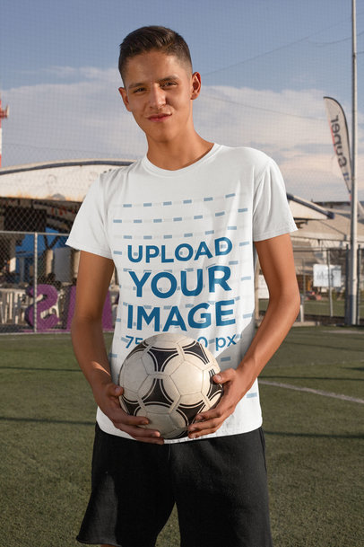 T-Shirt Mockup of a Teenage Boy Holding a Soccer Ball