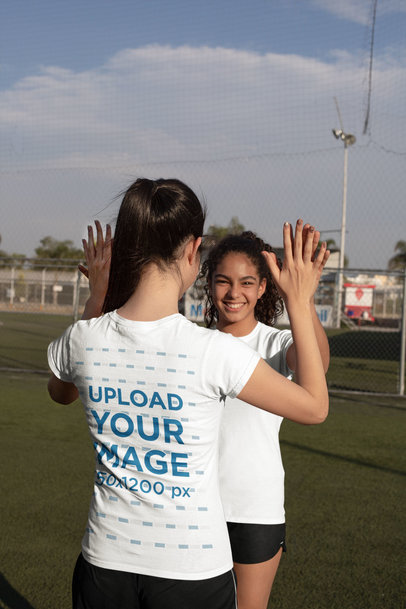 T-Shirt Mockup of a Girl Celebrating with Her Soccer Teammate 