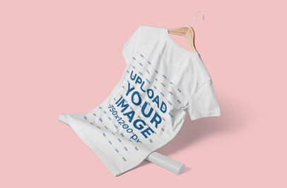 Mockup of a T-Shirt on a Hanger Featuring a Plain-Color Setting