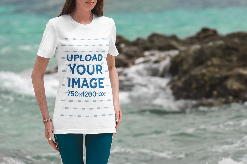 T-Shirt Mockup Featuring a Woman and the Sea in the Background
