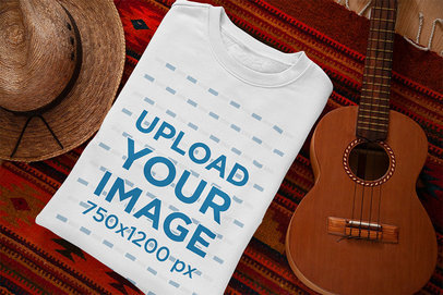 Mockup Featuring a Folded Crewneck Sweatshirt Placed Next to a Ukulele 