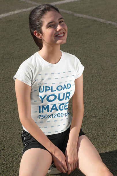 T-Shirt Mockup Featuring a Teenage Girl in a Soccer Field