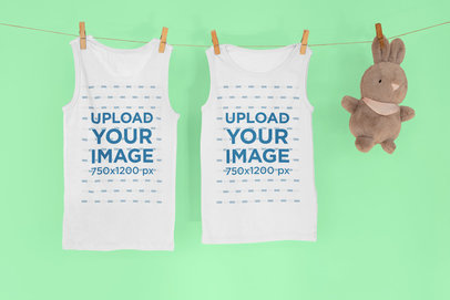 Mockup of Two Tank Tops Hanging Next to a Stuffed Animal 33957