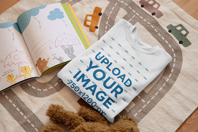 Mockup of a Folded T-Shirt on a Children's Room Mat 33995