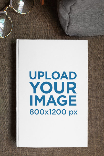 Mockup of a Hardcover Book Featuring Some Glasses