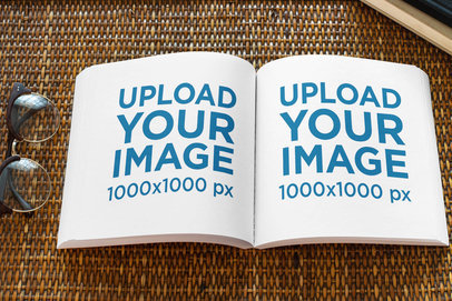 Mockup Featuring an Open Square Book Placed by a Pair of Reading Glasses 