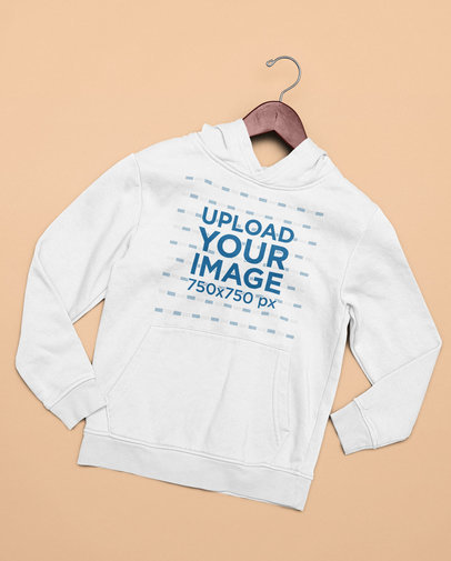 Mockup of a Flat Laid Hoodie with a Clothes Hanger