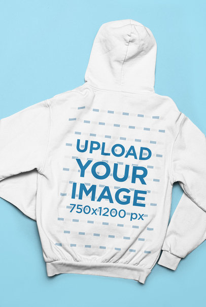 Back-View Mockup of a Hoodie Lying over a Solid Surface