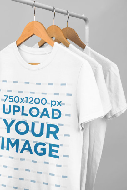 Mockup of a Series of T-Shirts Hanging From a Rack