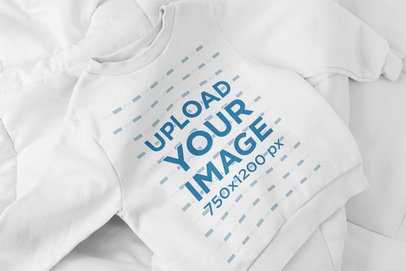 Mockup of a Crewneck Sweatshirt for Kids Placed on a Bed