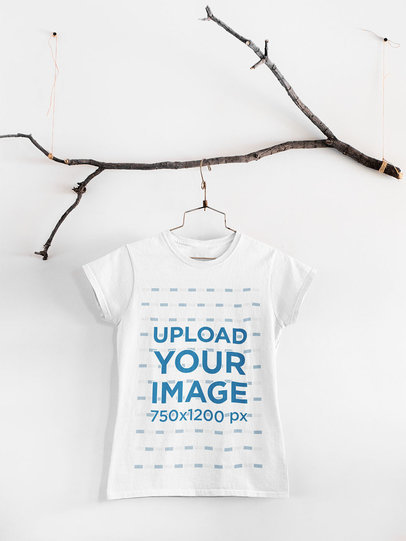 Mockup of a Basic T-Shirt Hanging From an Ornamental Tree Branch 