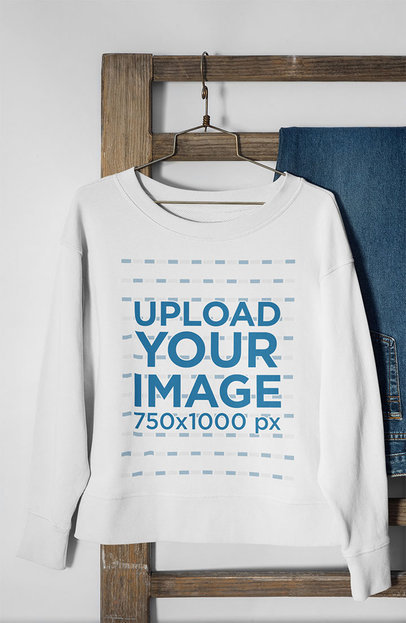 Mockup of a Women's Crewneck Sweatshirt Hanging From a Wooden Rack 