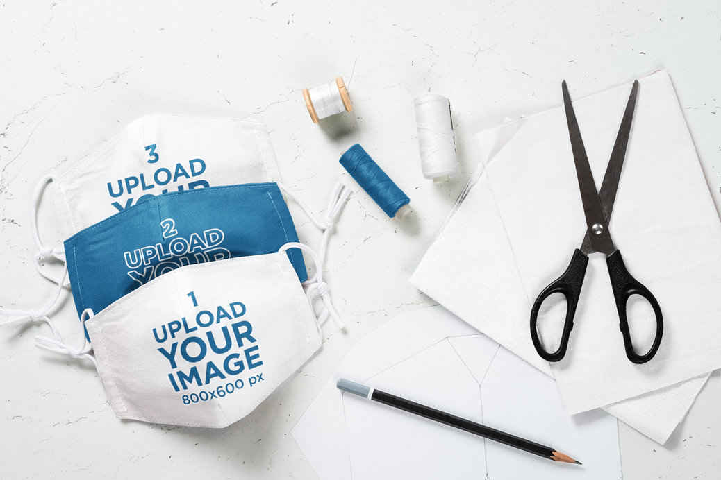 Mockup of a Series of Face Masks Surrounded by Sewing Materials