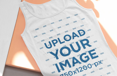 Mockup of a Flat Lay Tank Top Placed on an Orange Surface