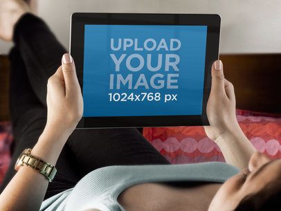 iPad Mockup Featuring a Woman Lying on Her Bed 