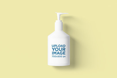 Mockup of a Hand Sanitizer Lying on a Colored Surface 
