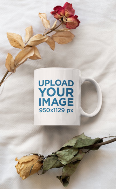 Mockup of a Coffee Mug Placed Between Two Dried Roses 