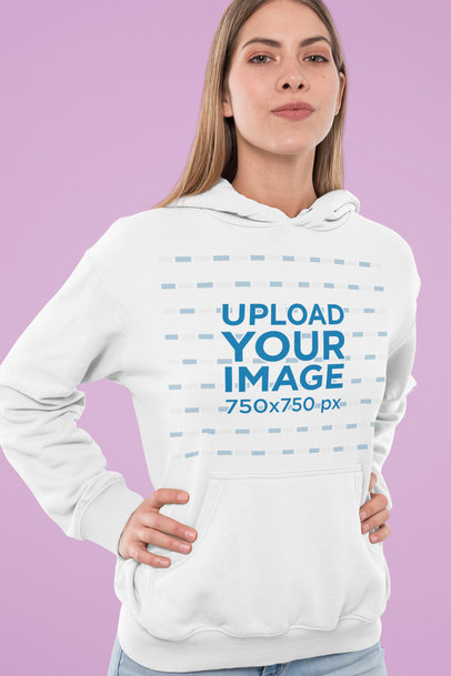 Mockup of a Young Woman Wearing a Hoodie in a Studio