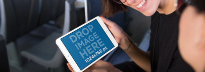 Smiling Young Woman Riding on a Bus with her iPad Mini in Landscape Position Mockup a12957w