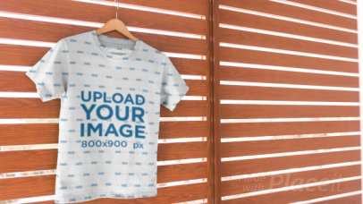 Video of a Sublimated T-Shirt Hanged on a Wooden Surface 13858