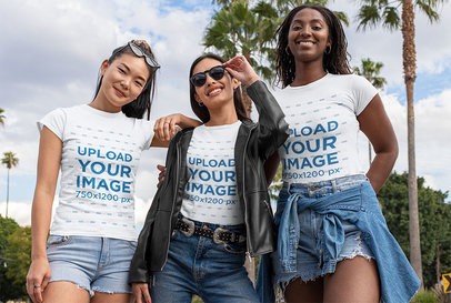 Mockup of Three Smiling Women Wearing T-Shirts