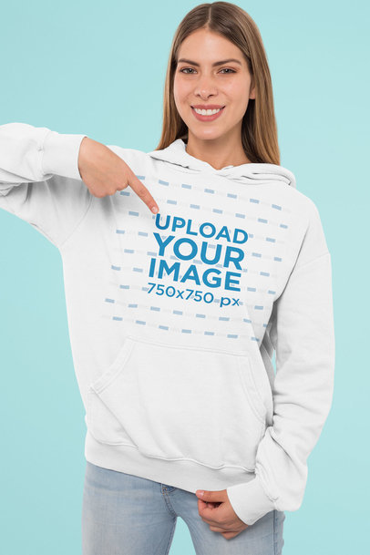 Mockup Featuring a Woman Pointing at Her Customizable Pullover Hoodie 
